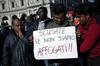 Degli immigrati manifestano il loro disappunto.